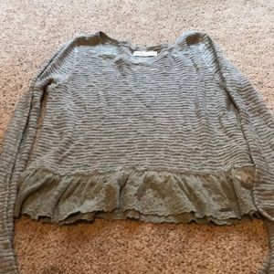Sweater with lace trim.